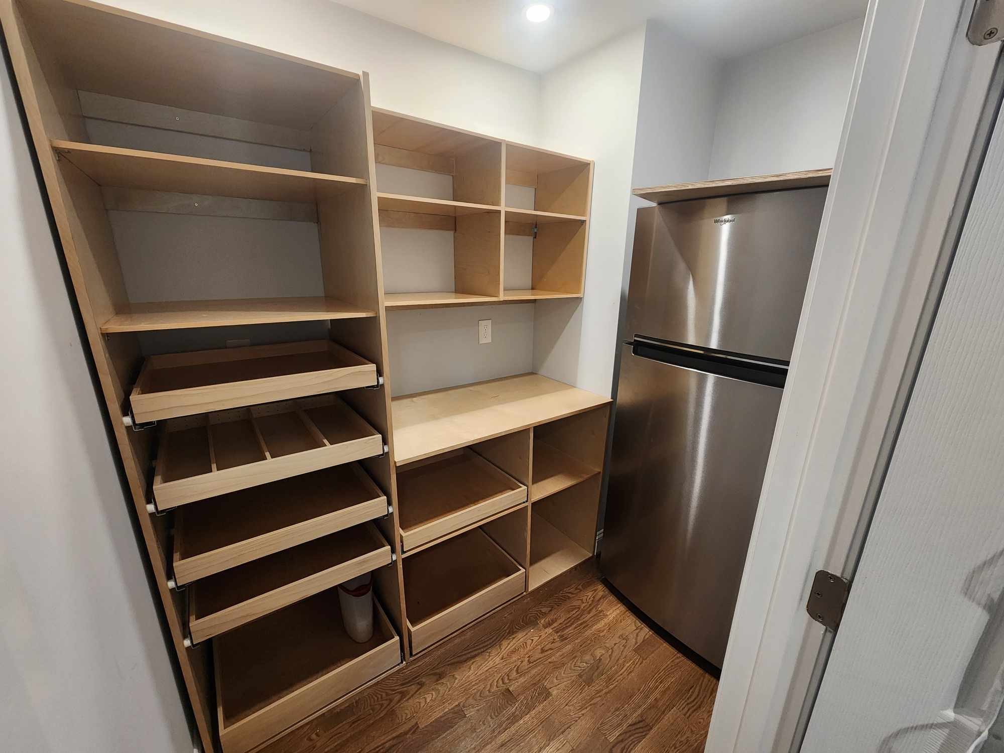 Custom pantry shelving with pull-out drawers
